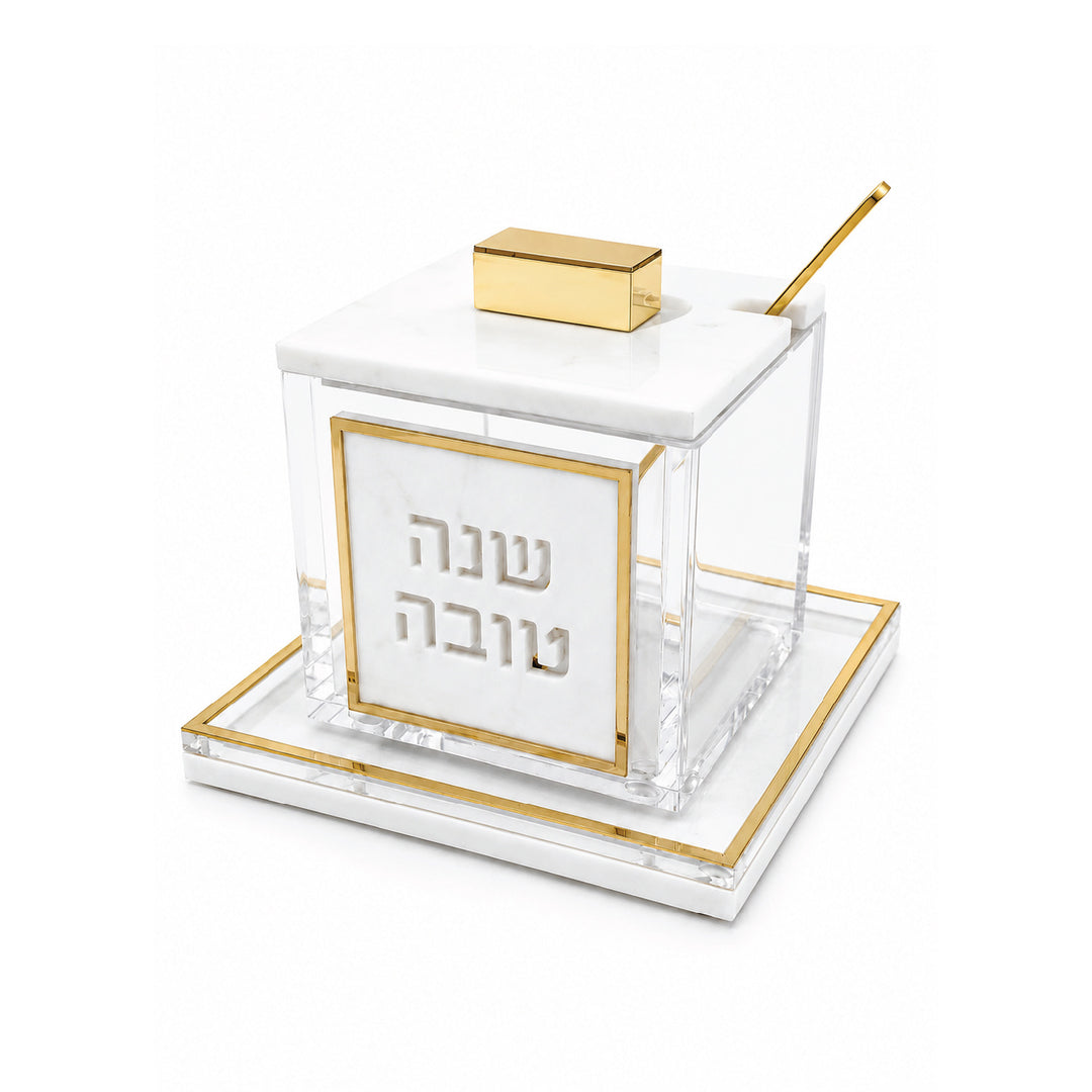 Gold Rimmed marble and lucite honey dish with gold spoon, angled view